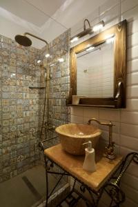 a bathroom with a sink and a mirror at Apartment Wine House in Sibiu