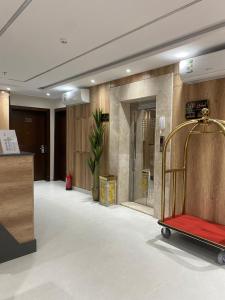 a lobby with a red luggage cart in a room at رامة المدينة للشقق المخدومة in Sīdī Ḩamzah