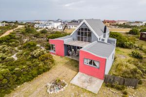 an aerial view of a red and white house at Mountain View in Bettyʼs Bay