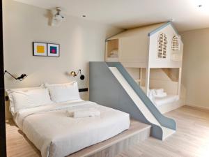 a bedroom with a bunk bed and a staircase at VIENTO RedHouse Melaka by Rest Collection in Malacca