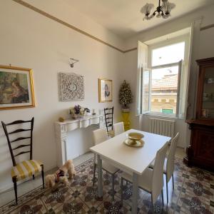a dining room with a white table and chairs at L'Una di Notte in Salerno +22 photos