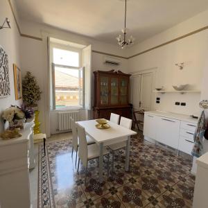 a kitchen with a table and chairs and a window at L'Una di Notte in Salerno
