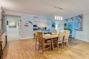 a dining room and kitchen with a table and chairs at Sandy Shores Condominium in Biloxi
