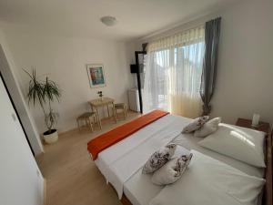 a bedroom with a large white bed with pillows on it at Sobe-Sandra in Dramalj +13 photos