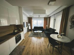 a living room with a couch and a table at Apartman Zdravko in Tomislavgrad