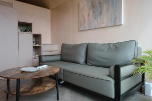 a living room with a couch and a table at Gold LUX in Kuldīga