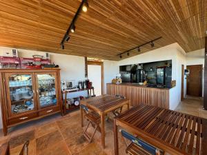 a kitchen with a wooden ceiling and a table at Pousada Amazing Jeri in Jericoacoara