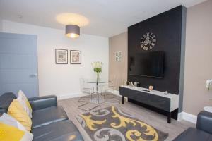 un soggiorno con un divano e un tavolo di Beautifully Designed Pollok House a Glasgow