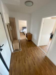 an empty room with a bed and a wooden floor at Apartman BM2 in Posušje