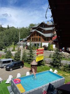 a woman is in a swimming pool in a house at Girskiy Prutets in Bukovel