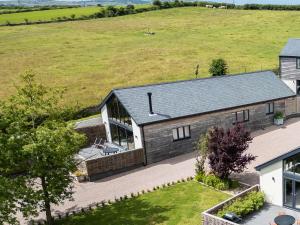 an aerial view of a house with a lawn at The Barn in Amlwch