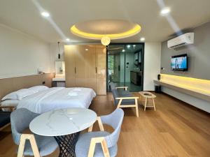 a hotel room with a bed and a table and chairs at Sokview Residence in Luang Prabang