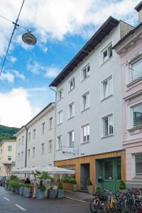 a large white building with bikes parked in front of it at Salzburg Topside Apartments in Salzburg