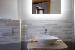 a bathroom with a white sink and a mirror at Le Muse in Falerna Marina