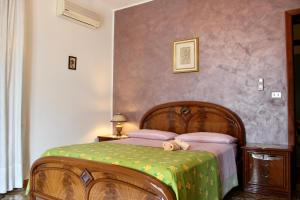 a teddy bear laying on a bed in a bedroom at Villa Maria - Sant'Angelo di Brolo in SantʼAngelo di Brolo