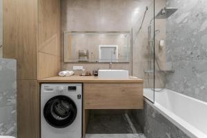a bathroom with a washing machine and a sink at Smart apartments in Lviv +231 photos