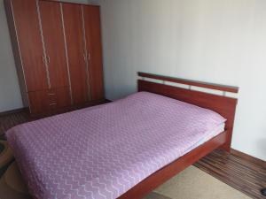 a bedroom with a bed with a purple mattress at Apartman Leki in Sarajevo