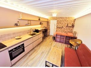 a kitchen with a couch and a table in a room at Maison Juliette in Clichy