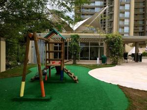 a playground with a slide on a green lawn at Apartamento - Condominio Zazué in Santa Marta