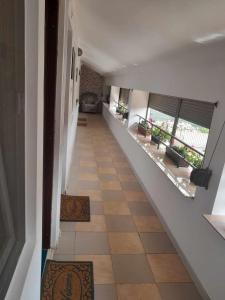 a hallway of a house with a staircase with rugs at Casa Octavia in Schitul