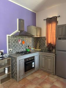 a kitchen with a sink and a stove top oven at Dream House in San Giovanni Suergiu +5 photos