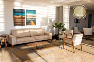 a living room with a couch and a table and chairs at GoldMen Express Cianorte in Cianorte
