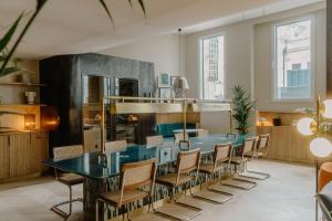 a dining room with a blue table and chairs at Club Quarters Hotel St Paul's, London in London