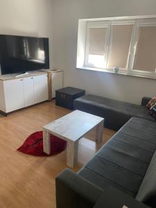 a living room with a couch and a coffee table at Apartman MB in Posušje