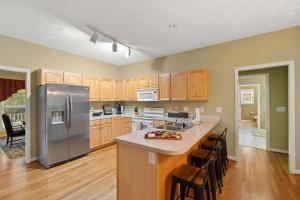 a kitchen with wooden cabinets and a stainless steel refrigerator at 88 Deerwood Lane in Pinehurst