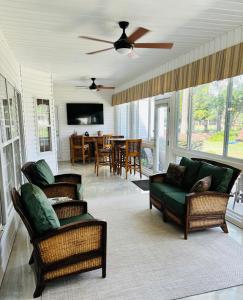 a living room with two chairs and a couch and a table at 88 Deerwood Lane in Pinehurst