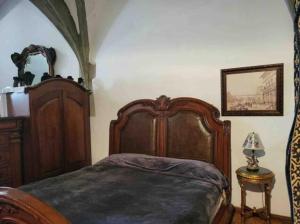 a bedroom with a bed with a wooden bed frame at Burg Hermannstein - Queens Room in Wetzlar
