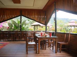 a dining area with tables and chairs in a restaurant at Orau Asthana in Arau