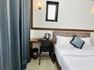 Lova arba lovos apgyvendinimo įstaigoje TCS Rooms Ezhilode Payyanur