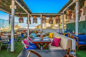 a patio at a restaurant with tables and chairs at Bianca 903 Loft at Morgan Residences in Cabo San Lucas