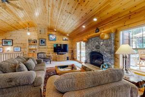 a living room with two couches and a stone fireplace at Modern Mountain Home in Kings Beach
