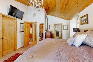 a bedroom with a large bed and a wooden ceiling at Modern Mountain Home in Kings Beach