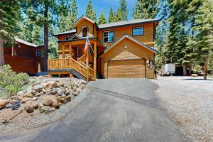 a large wooden house with a driveway in front of it at Modern Mountain Home in Kings Beach