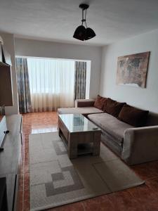Una sala de estar con un sofá y una mesa de café. en Mari's By The Sea, en Mangalia
