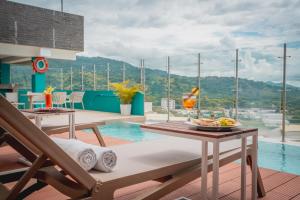a room with a pool and a table with a plate of food at Holiday Inn Express Yopal by IHG in Yopal