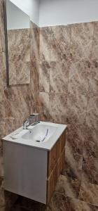 a bathroom with a sink and a mirror at Villa Eliada in Tuzla