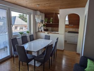 a kitchen and dining room with a table and chairs at Apartment Bee near Bled in Zabreznica