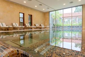 an empty lobby with chairs and a glass floor at Casa Velha do Palheiro Relais & Chateaux in Funchal
