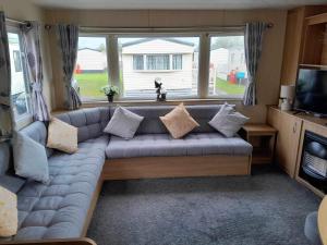 a living room with a couch in a caravan at Escape to the bay- arnside escapes in Morecambe