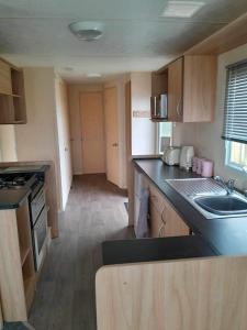 a small kitchen with a sink and a counter top at Escape to the bay- arnside escapes in Morecambe