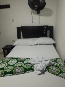 Postel nebo postele na pokoji v ubytování Hotel Villa Rocio Curumani