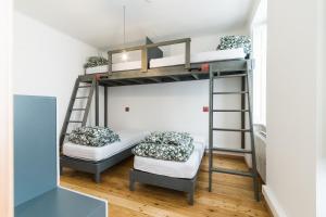 a bunk bed in a room with two beds at WOT Lisbon Patio in Lisbon