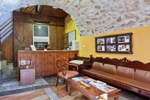 a living room with a couch and a table at Byzantino Boutique Hotel in Monemvasia
