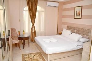 Postel nebo postele na pokoji v ubytování Nun Pyramids Hotel + 31 fotografií