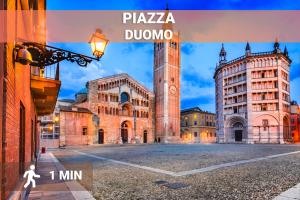a picture of a building with a clock tower at DUOMO Relax in centro, WiFi, Aria Condizionata in Parma