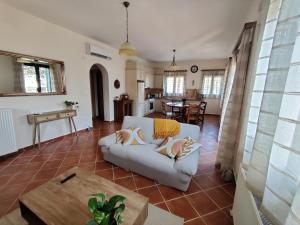 a living room with a couch and a table at Casa Katerina 1892 in Poros